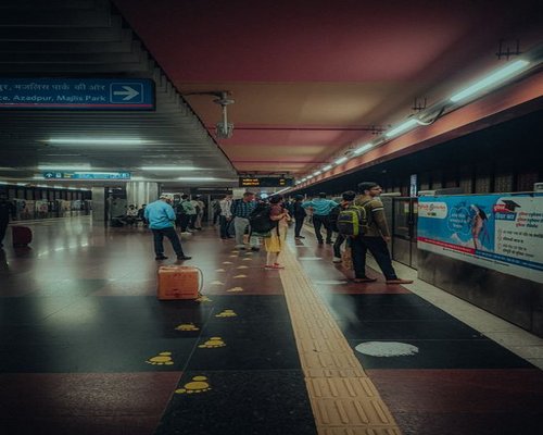 Commuters walking calmly outside a metro station in Delhi